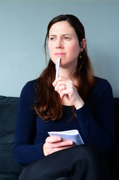 Young woman thinking about to do list at home — Stock Photo, Image