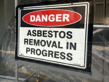 Sign reads: Danger - Asbestos removal in progress clipart
