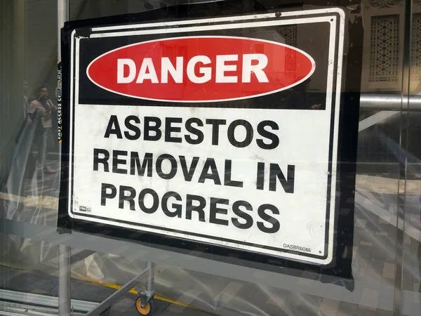 Sign reads: Danger - Asbestos removal in progress — Stock Photo, Image