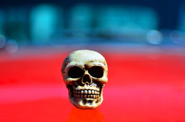 Skeleton on a red sports muscle car — Stockfoto