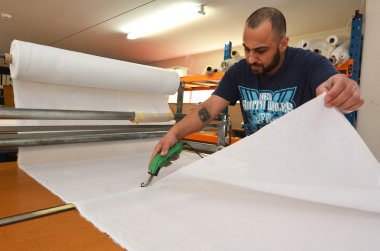 Worker cut new fabric sheet for the new National flag of New Zea clipart