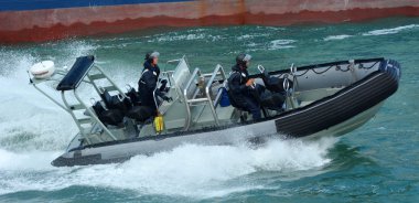 Royal New Zealand navy sailors ride a Zodiak Rigid-hulled inflat