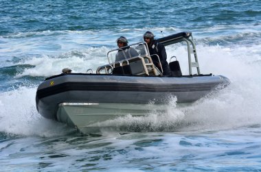 Royal New Zealand navy sailors ride a Zodiak Rigid-hulled inflat