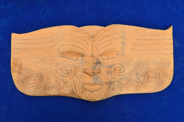 Maori man face wood carving sculpture