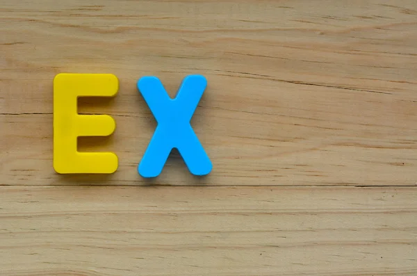 Top lay of the word Ex on a wooden background. — Stock Photo, Image