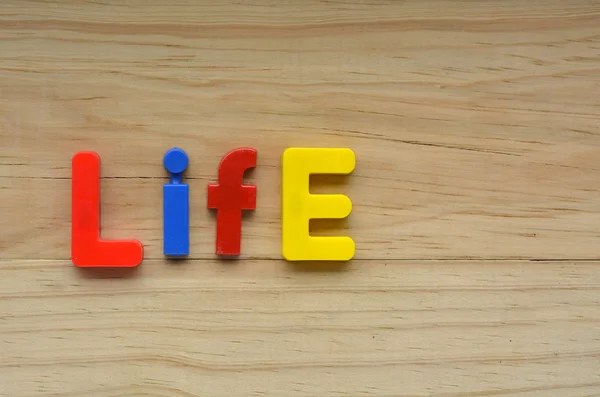 Top lay of the word Life on a wooden background — Stock Photo, Image