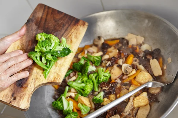 Adding broccoli Stock Picture