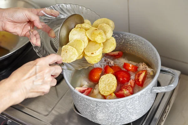 Add potato to the cooking in pan — Stock Photo, Image