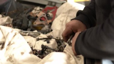 The Craftsman Serviceman Car  In The Repair Shop Lets The Suitable Screws While Gathering