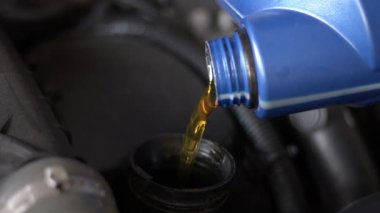 Motor Synthetic Oil Pouring To Car Engine. Synthetic Oils for Protecting Cars Engine Footage.