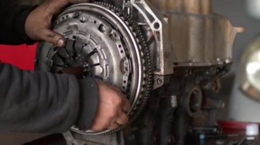 Auto Car Mechanic In Workshop Clutch Set Is Installed On The Repaired Car Engine Footage.