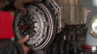 Auto Car Mechanic In Workshop Clutch Set Is Installed On The Repaired Car Engine Footage.