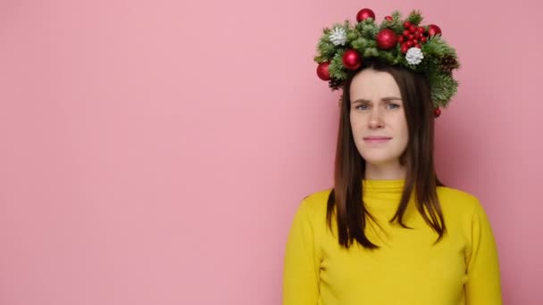 Mujer Joven Disgustada Tradicional Corona Navidad Mirada Señalando Lado Espacio — Vídeo de stock