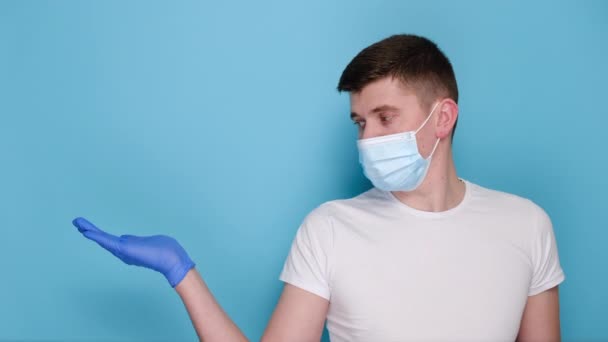 Young Male Holds Paper White Arrow Wears Respirator Face Mask — Stock Video