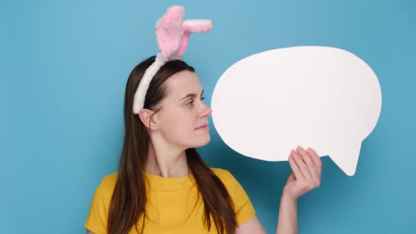 Portrait Young Happy Woman Bunny Fluffy Ears Holding Speech Bubble — Stock Video