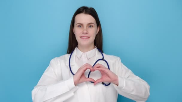 Lovely Caring Young Woman Doctor Showing Heart Gesture Smiling Taking — Stock Video