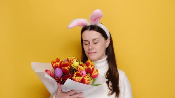 Весела Жінка Пухнастих Вухах Тримає Букет Весняних Квітів Прикрашений Великодніми — стокове відео