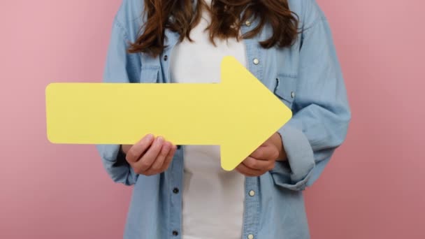 Close Cropped Female Blogger Holding Big Yellow Paper Arrow Small — Stock Video