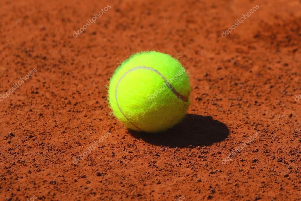 Tennis ball at red clay tennis court