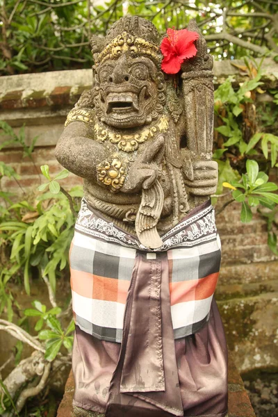 Traditional demon statue carved in stone on Bali Stock Image
