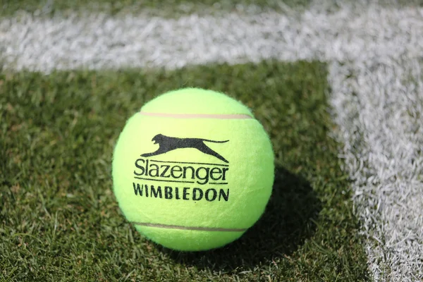 Slazenger Wimbledon Tennis Ball on grass tennis court. — Stock Photo, Image