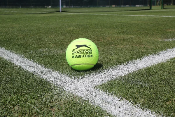 Slazenger Wimbledon Tennis Ball on grass tennis court. — Stock Photo, Image