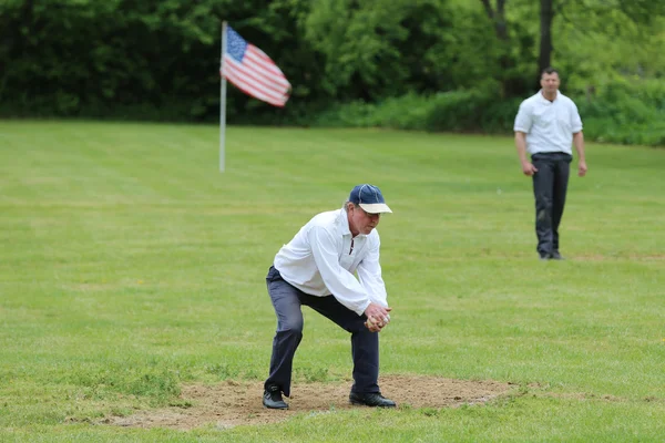 Baseball team in 19th century vintage uniform during old style base ball play following the rules and customs from 1864