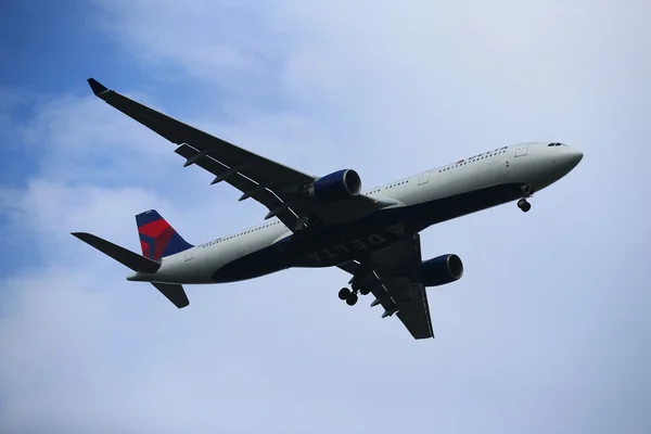 Delta Air Lines Airbus A330 descending for landing at JFK International Airport in New York — Stock Photo, Image