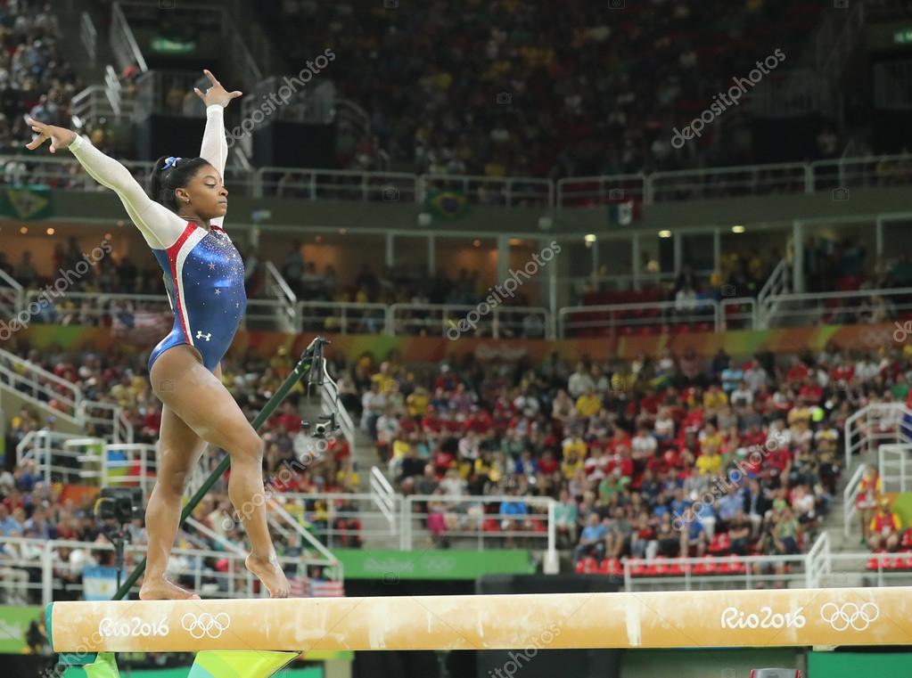 RIO DE JANEIRO, BRAZIL - AUGUST 11, 2016: Olympic champion Simone Biles of United States competing on the balance beam at women's all-around gymnastics at Rio 2016 Olympic Games
