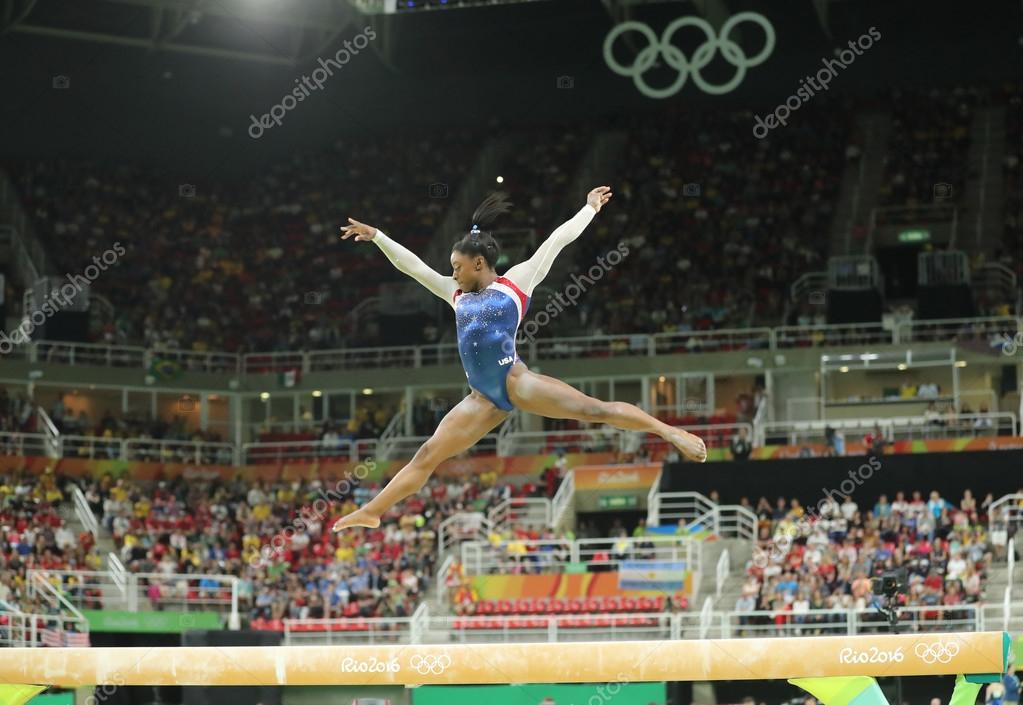 RIO DE JANEIRO, BRAZIL - AUGUST 11, 2016: Olympic champion Simone Biles of United States competing on the balance beam at women's all-around gymnastics at Rio 2016 Olympic Games