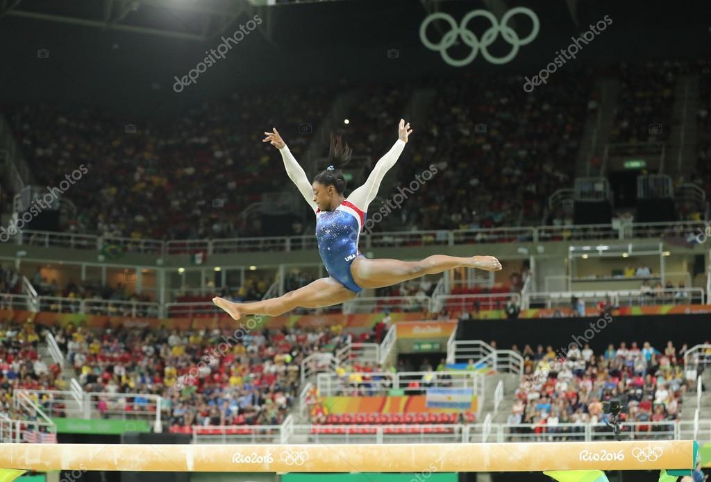 RIO DE JANEIRO, BRAZIL - AUGUST 11, 2016: Olympic champion Simone Biles of United States competing on the balance beam at women's all-around gymnastics at Rio 2016 Olympic Games