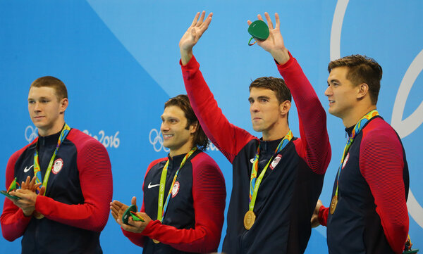 USA Men's 4x100m medley relay team Ryan Murphy (L), Cory Miller,  Michael Phelps and Nathan Adrian celebrate victory at the Rio 2016 Olympic Games 