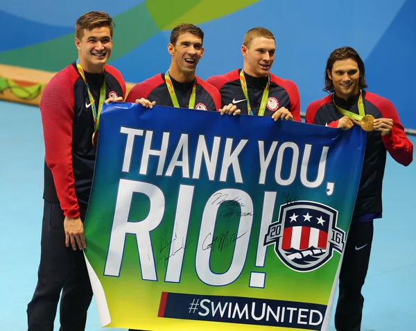 USA Men's 4x100m medley relay team Nathan Adrian(L),  Michael Phelps, Ryan Murphy and Cory Miller celebrate victory — Stock Photo, Image