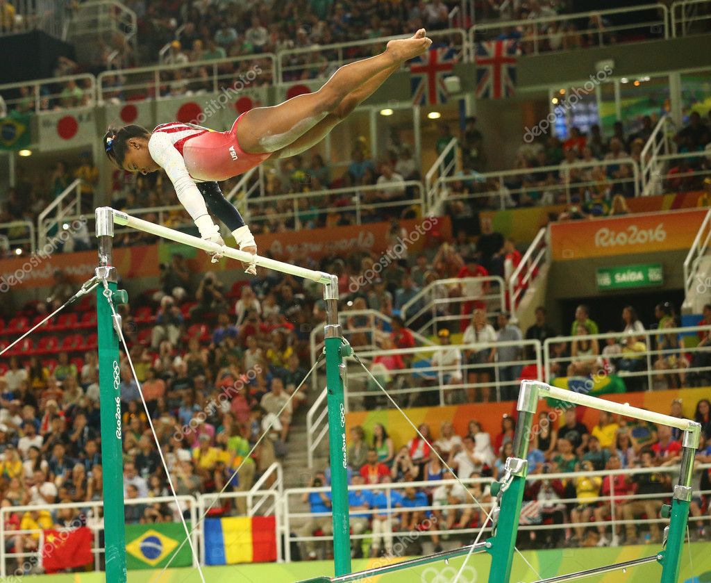 RIO DE JANEIRO, BRAZIL - AUGUST 9, 2016: Olympic champion Simone Biles of United States competes on the uneven bars at women's team all-around gymnastics at Rio 2016 Olympic Games at Rio Olympic Arena