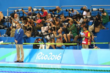 Sport photographers shooting swimming competition at Olympic Aquatic Center during Rio 2016 Olympic Games  clipart