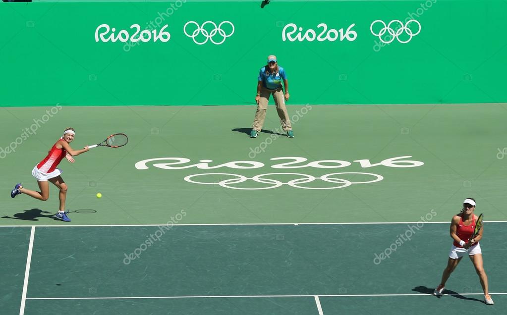 RIO DE JANEIRO, BRAZIL - AUGUST 14, 2016: Timea Bacsinszky (L)  and Martina Hingis iof Switzerland in action during women's doubles final  of the Rio 2016 Olympic Games at the Olympic Tennis Centre