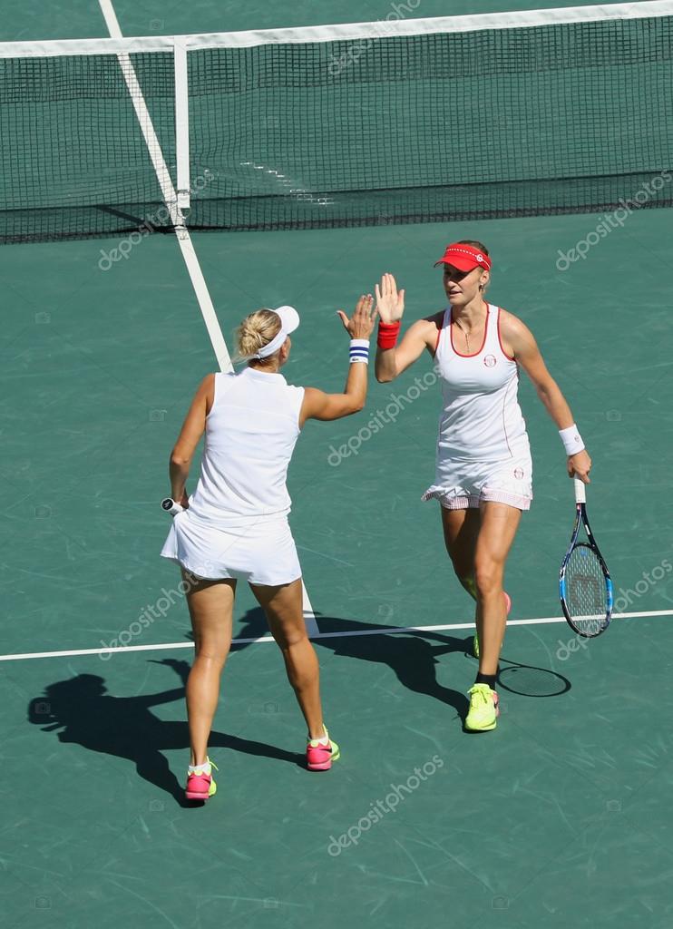 RIO DE JANEIRO, BRAZIL - AUGUST 14, 2016: Elena Vesnina (L) and  Ekaterina Makarova of Russia in action during women's doubles final  of the Rio 2016 Olympic Games at the Olympic Tennis Centre