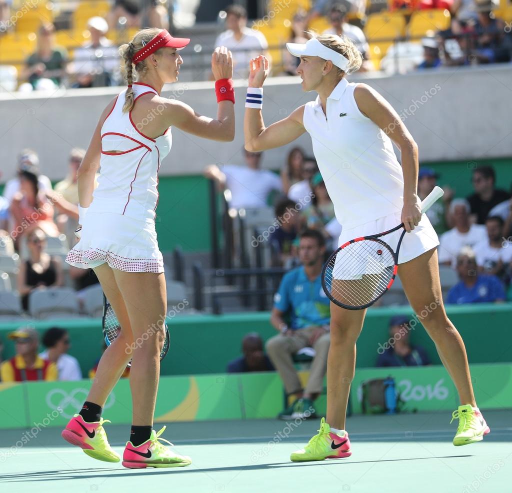 RIO DE JANEIRO, BRAZIL - AUGUST 14, 2016: Ekaterina Makarova (L) and Elena Vesnina of Russia in action during women's doubles final  of the Rio 2016 Olympic Games at the Olympic Tennis Centre
