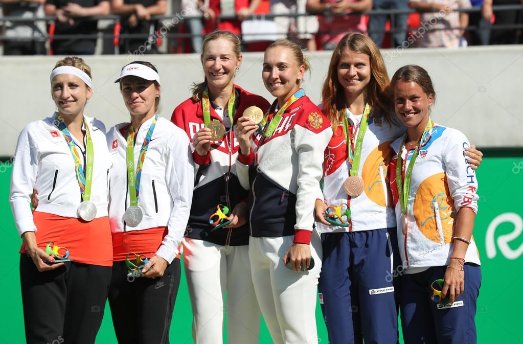 RIO DE JANEIRO, BRAZIL - AUGUST 14, 2016:Tennis women's doubles medalists team Switzerland (L), team Russia and team Czech during medal ceremony of the Rio 2016 Olympic Games at Olympics Tennis Centre