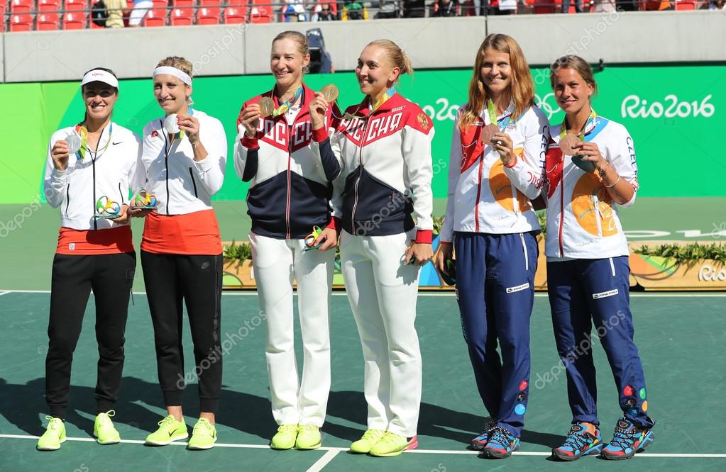 RIO DE JANEIRO, BRAZIL - AUGUST 14, 2016:Tennis women's doubles medalists team Switzerland (L), team Russia and team Czech during medal ceremony of the Rio 2016 Olympic Games at Olympics Tennis Centre