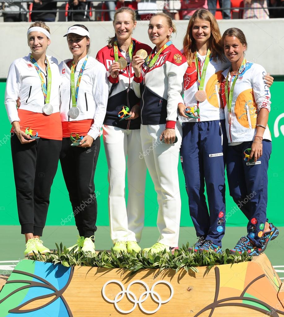 RIO DE JANEIRO, BRAZIL - AUGUST 14, 2016:Tennis women's doubles medalists team Switzerland (L), team Russia and team Czech during medal ceremony of the Rio 2016 Olympic Games at Olympics Tennis Centre