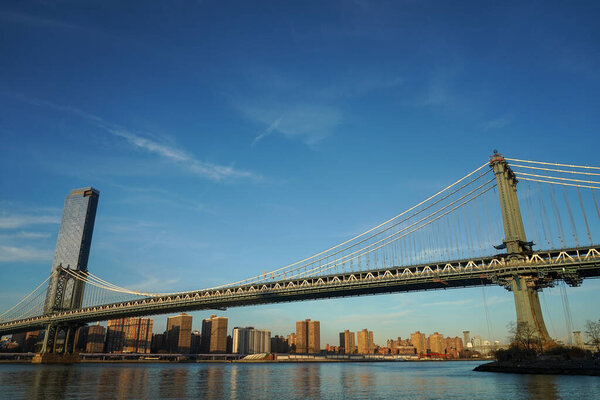 NEW YORK - NOVEMBER 29, 2020: One Manhattan Square residential skyscraper and Manhattan Bridge