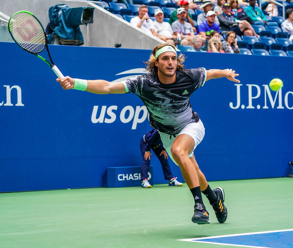 NEW YORK - AUGUST 27, 2019: Professional tennis player Stefanos Tsitsipas of Greece in action during his 2019 US Open first round match at Billie Jean King National Tennis Center in New York