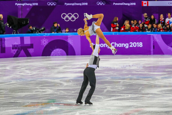 GANGNEUNG, SOUTH KOREA - FEBRUARY 9, 2018: Olympic Champions Aljona Savchenko and Bruno Massot of Germany perform in the Team Event Pair Skating Short Program at the 2018 Winter Olympic Games