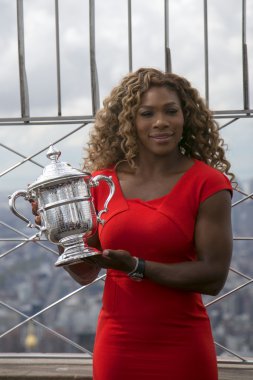 US Open 2014 champion Serena Williams posing with US Open trophy on the top of Empire State building clipart