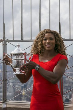 US Open 2014 champion Serena Williams posing with US Open trophy on the top of Empire State building clipart