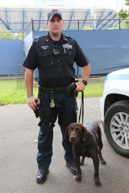 NYPD transit bureau K-9 police officer and Labrador K-9 Ellis providing security at National Tennis Center during US Open 2014 clipart
