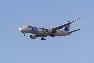 EgyptAir Boeing 777 in New York sky before landing at JFK Airport clipart