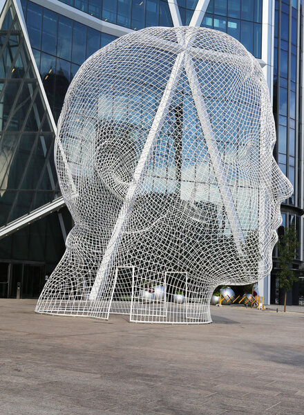 Wonderland sculpture by Jaume Plensa in the front of the Bow Tower in Calgary