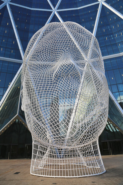 Wonderland sculpture by Jaume Plensa in the front of the Bow Tower in Calgary